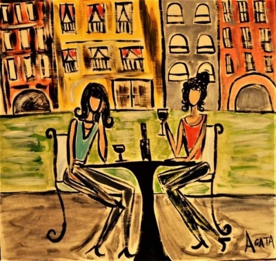 two women at table with wine