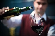 man pouring a glass of wine